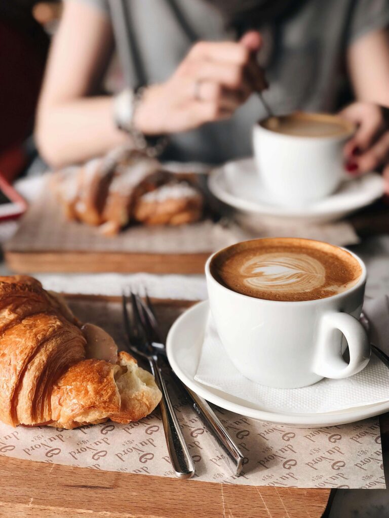Italian breakfast with espresso and croissant at a local café in Florence”