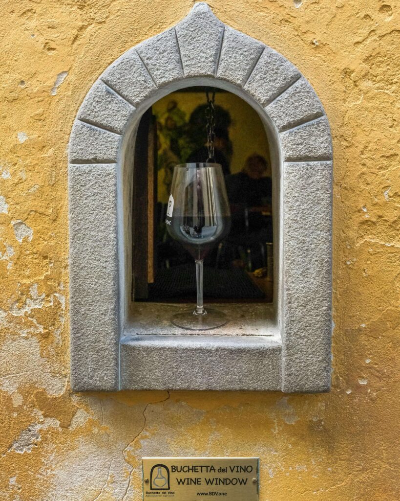 Buchette del Vino – Florence’s Wine Windows, one of the most unusual things to do in Florence for young adults, a hidden gem where visitors can taste local wine through tiny historic windows in Florence Italy