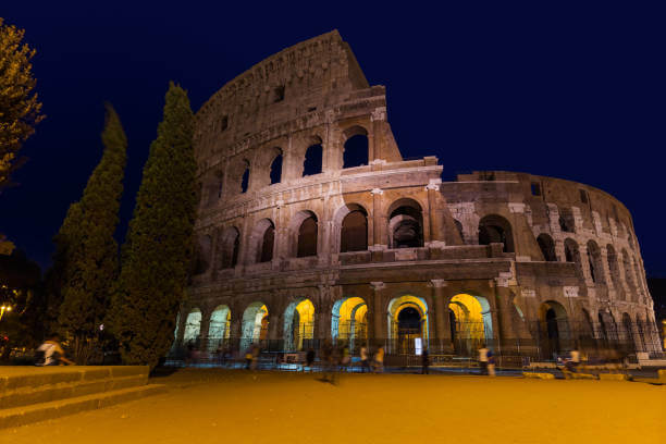 Colosseum in Rome glowing at night during after-hours VIP tour