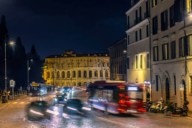 Night bus in Rome passing illuminated streets