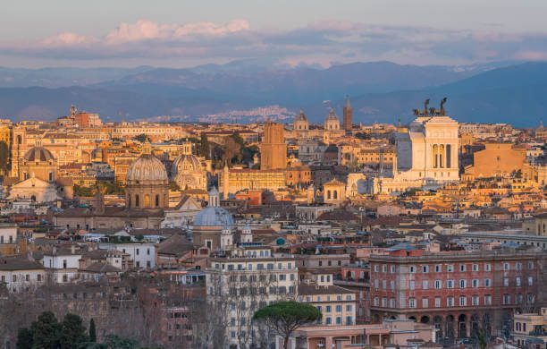 Sunset view over Rome with city lights beginning to glow from Gianicolo Hill 