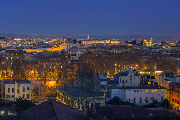 Sunset view over Rome with city lights beginning to glow