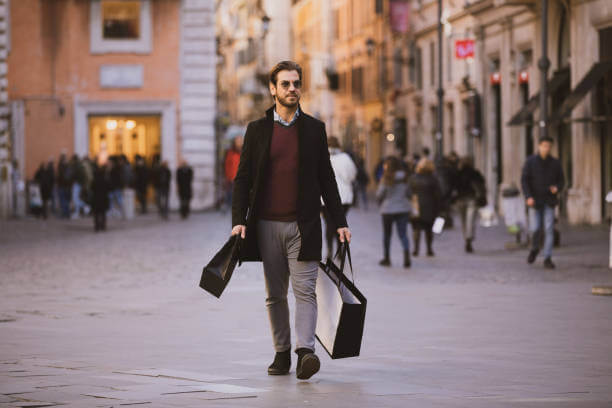 Traveler dressed smart-casual walking in Rome at night