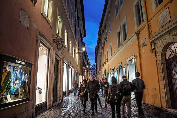 Well-lit street in Rome at night with tourists walking safely