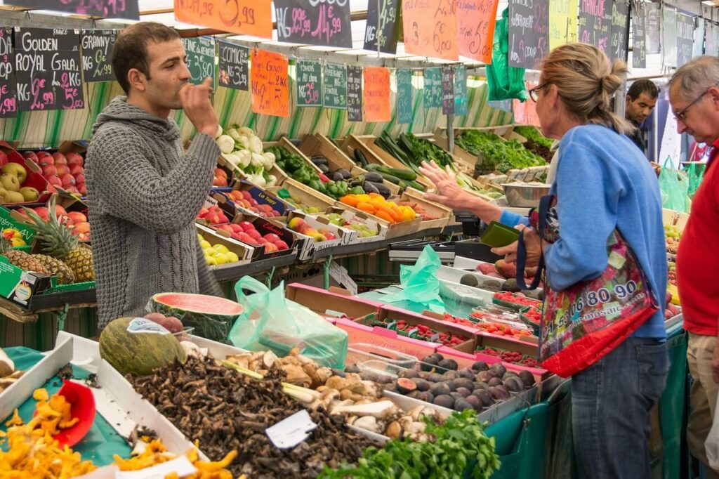 Seasonal food market in Rome Italy with fresh vegetables, cheese, and local specialties.