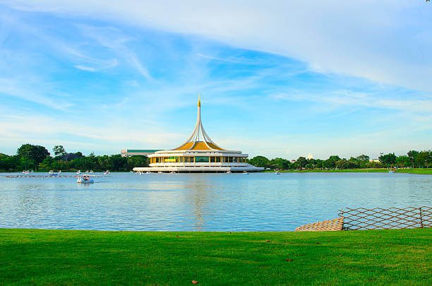 Serene gardens and lake at Rama IX Park in Bangkok