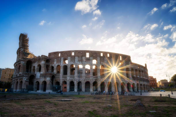 Colosseum exterior with morning sunlight and blue sky