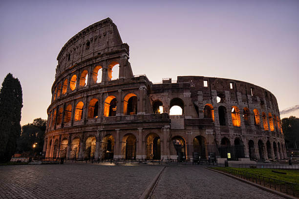 Colosseum glowing at sunrise with empty foreground