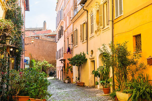 Trastevere’s colorful cobblestone streets with plants and lanterns, showcasing local Roman vibes.