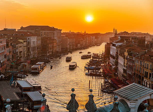 Aerial view of Venice Italy showing the Grand Canal, gondolas, and historic buildings at sunset