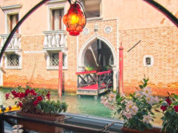 boutique hotel room with Venetian decor and canal view window