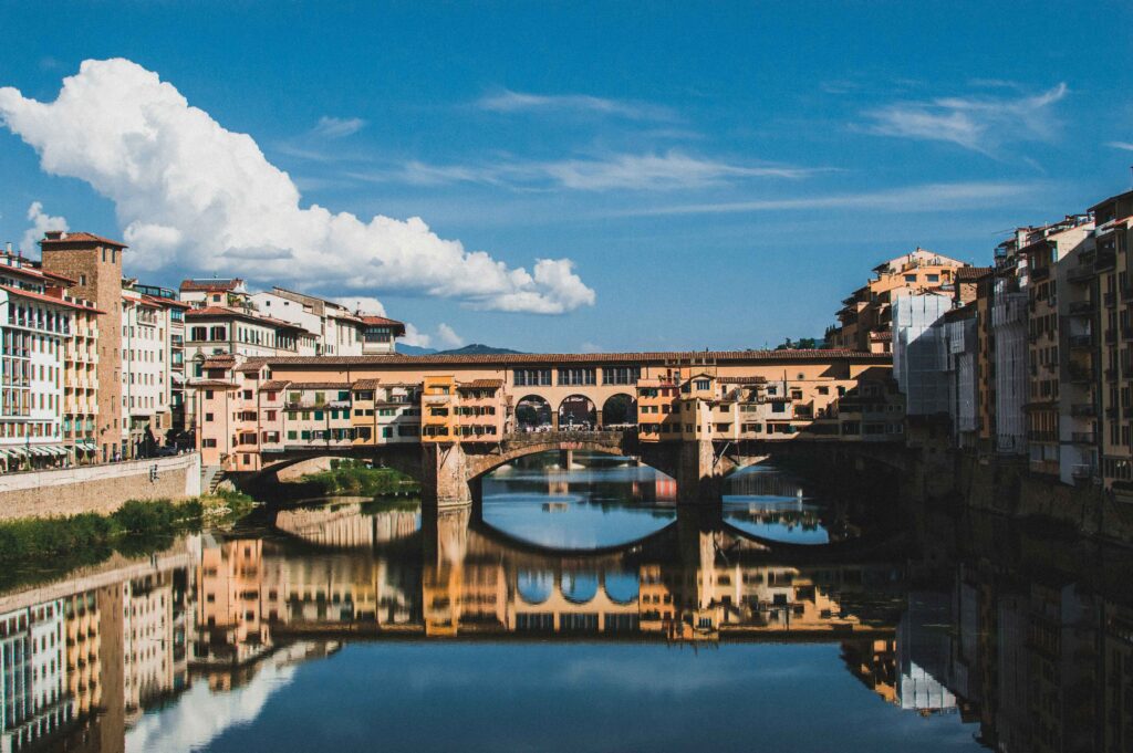 BEST PLACES TO VISIT IN ITALY IN OCTOBER Ponte Vecchio bridge with golden autumn light