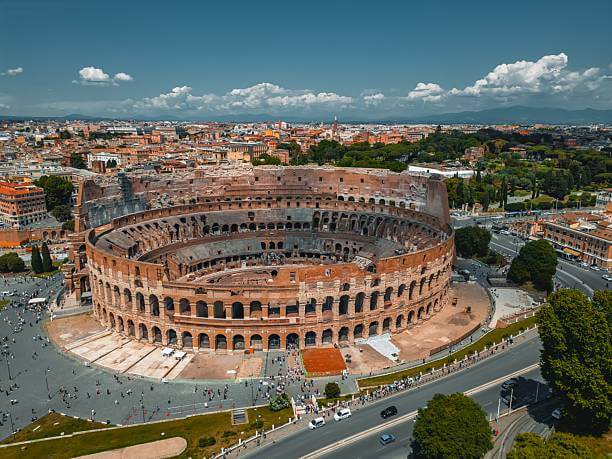 Ground-level photograph of the Colosseum in Rome on a clear October morning