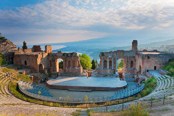 Sicily Taormina with turquoise Mediterranean sea and ancient Greek theatre in warm autumn sun