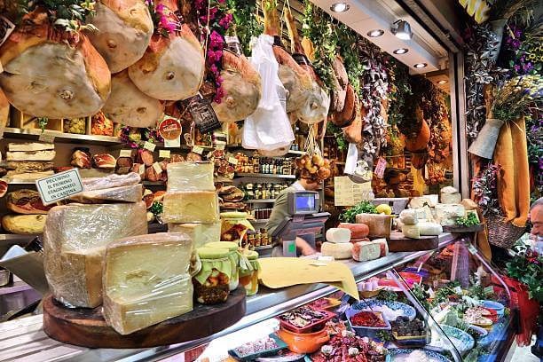 Evening food tour in Florence for solo travelers small group sampling street food at the Mercato di Sant'Ambrogio