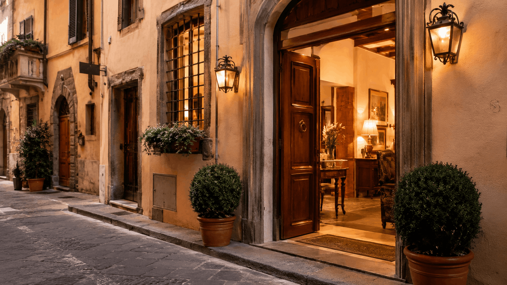 Hotels in Florence for solo travelers charming boutique hotel entrance in Oltrarno neighbourhood with warm secure reception and cobblestone street