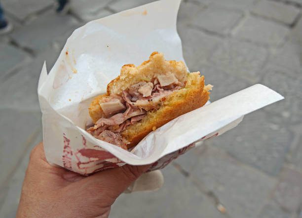 Lampredotto street food Florence solo traveller eating a lampredotto sandwich