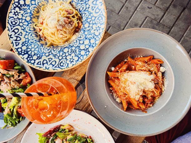 aperitivo bar with Aperol Spritz and generous free snack spread at Piazza di Santo Spirito