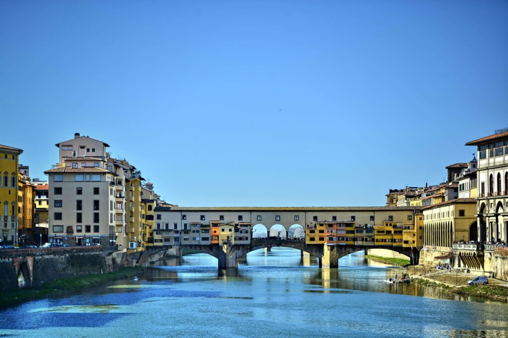 Ponte Vecchio over the Arno river with golden autumn trees
