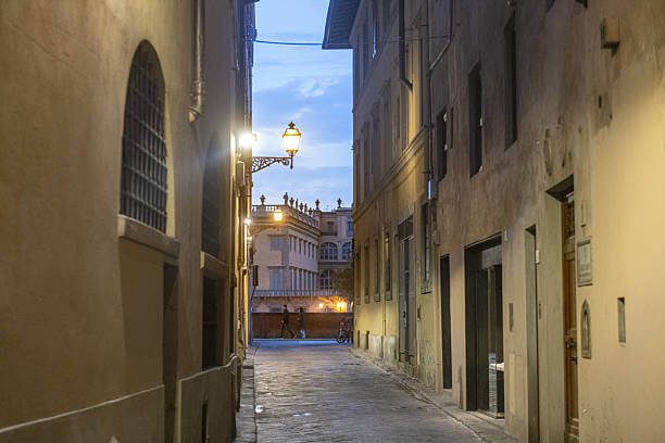 Best free solo activity in Florence solo traveler walking through a quiet Oltrarno cobblestone street 