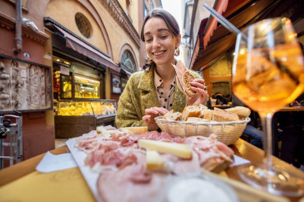 Bologna day trip from Florence solo traveler eating tagliatelle al ragù at a traditional Bologna trattoria representing Italy's food capital
