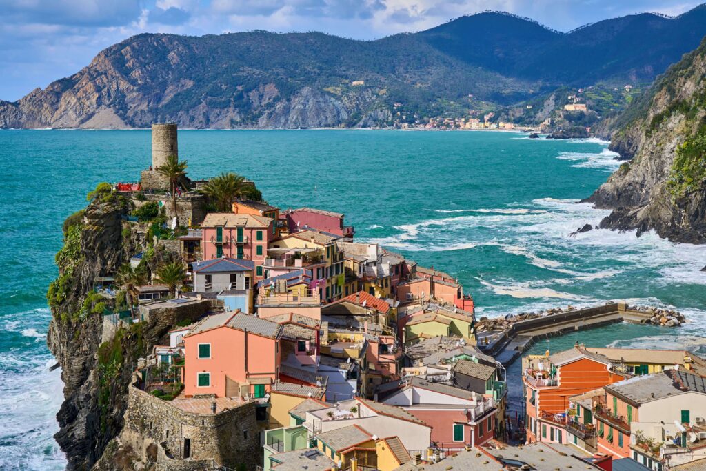 Cinque Terre day trip from Florence for solo travelers Vernazza village coastal view with turquoise sea and colourful houses