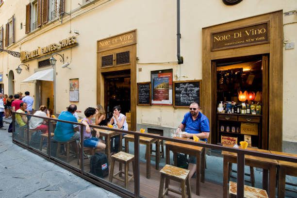 evening activity in Florence solo traveler at an aperitivo bar in Piazza di Santo Spirito with Aperol Spritz 
