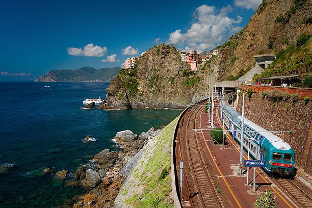 How to get to Cinque Terre solo traveler boarding the local Cinque Terre Express train at La Spezia station with the sea