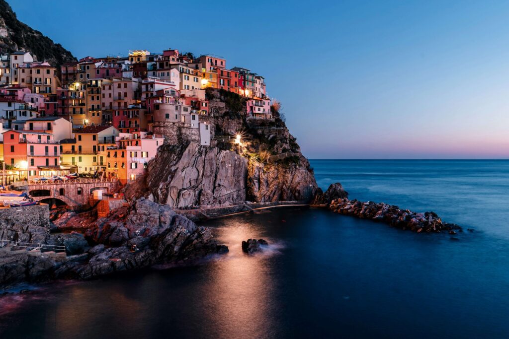 Manarola Cinque Terre solo the most photographed village with colourful houses stacked on black volcanic rock above the sea at golden sunset