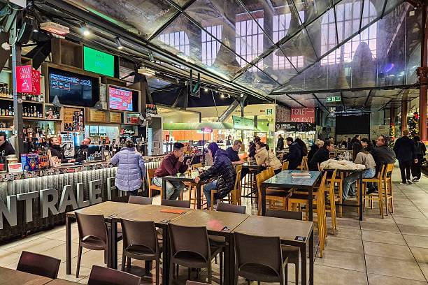 Florence solo traveler eating fresh pasta at a shared table in Mercato Centrale food hall